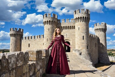 Blonde woman in red gown at castle