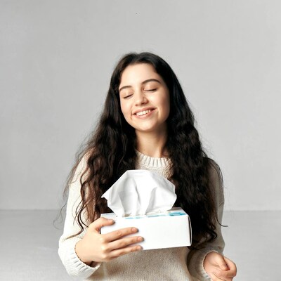 Woman holding tissue box