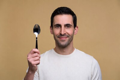 Man holding silver spoon