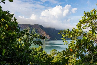 Tropical lake with misty mountains and foliage