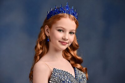 Girl with red hair wearing blue crown