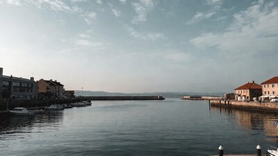 Boats in European Harbor with Buildings