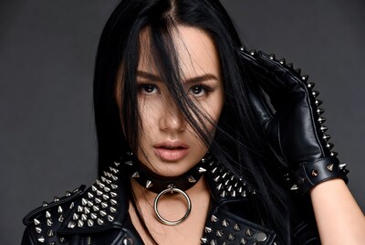 Asian woman in spiked leather outfit