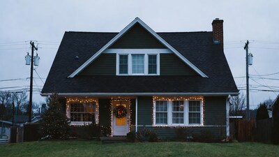 Green house with Christmas lights wreath