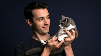 Man holding gray kitten