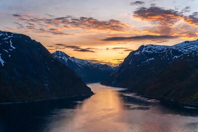 Sunset over Norwegian Fjord with Mountains