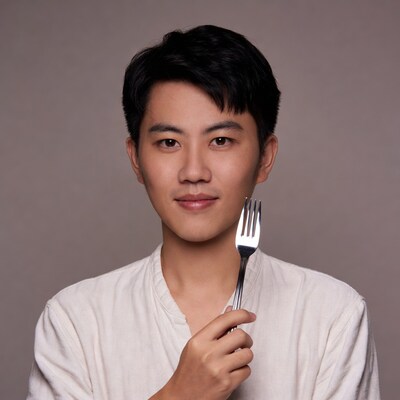 Asian man holding fork