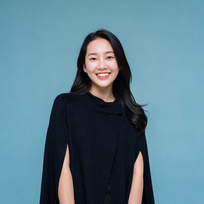 Asian woman smiling in black cape