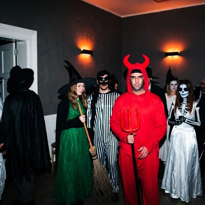 Halloween party with devil witch skeletons