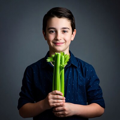 Boy holding celery stalks
