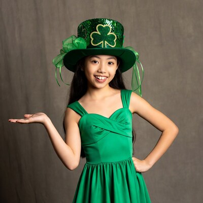 Asian girl in shamrock hat gesturing