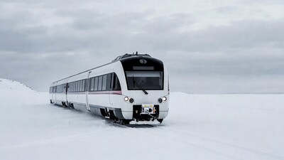 White train on snowy landscape