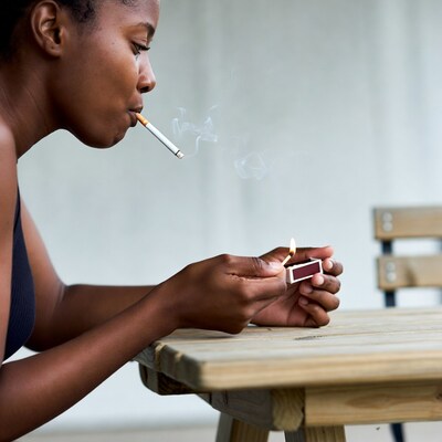 African-American woman smoking cigarette