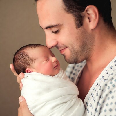 Father holding newborn baby