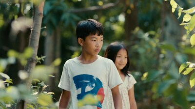 Asian boy and girl in forest