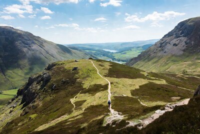 Hiker on mountain path with valley view