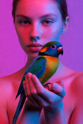 Woman holding colorful parrot