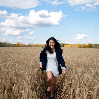 Woman running joyfully in wheat field
