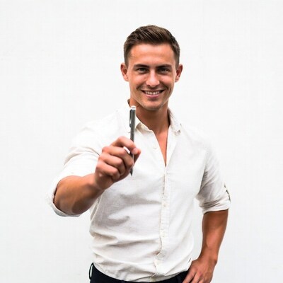 Smiling man holding pen