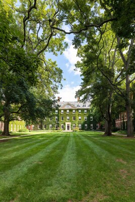 Ivy-covered building in green courtyard