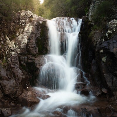 Waterfall cascading over mossy rocks