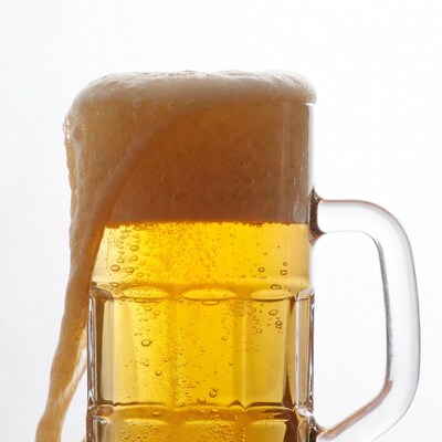 Beer mug with overflowing foam