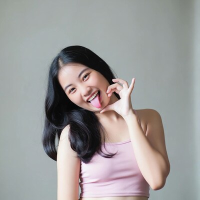 Asian girl sticking tongue out heart gesture