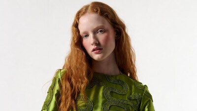 Redhead woman in green snake dress