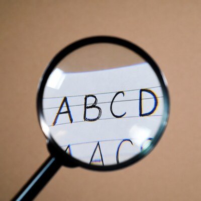 Magnifying glass over ABC letters