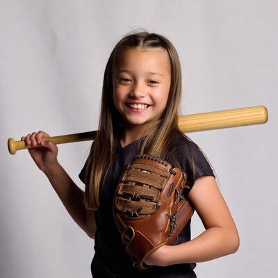 Girl holding baseball bat and glove