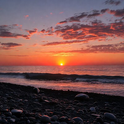 Sunset over pebbly beach