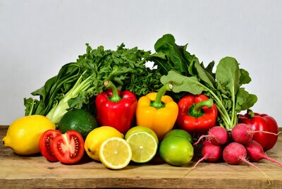Fresh vegetables and fruits on wooden board