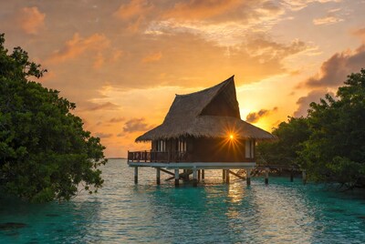 Overwater bungalow at sunset