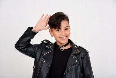 Boy in studded leather jacket waving hand