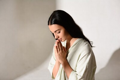 Woman praying with hands together
