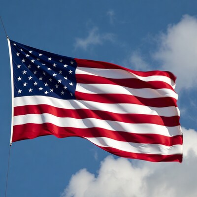 American flag waving in blue sky