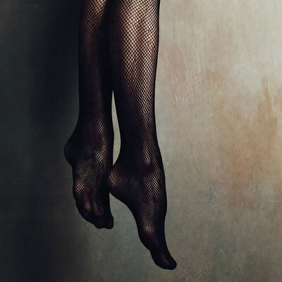 Woman's Legs in Black Fishnet Stockings