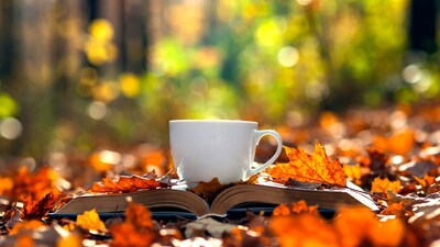 White Mug on Open Book with Autumn Leaves