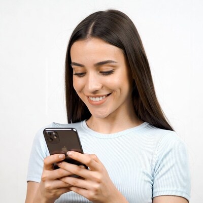 Woman smiling using smartphone