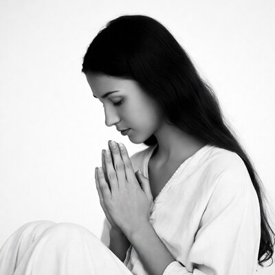 Woman praying with hands together