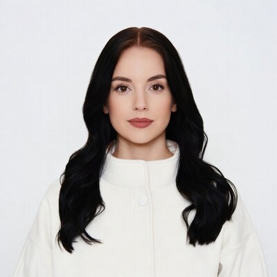 Woman with long black hair in white jacket