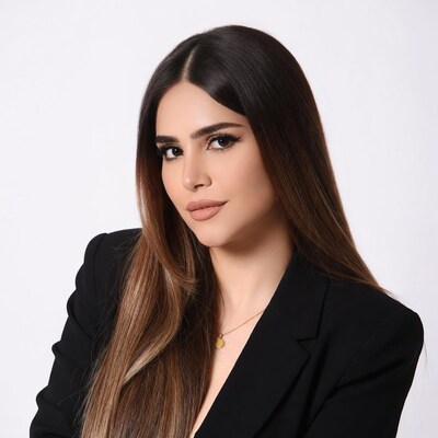 Woman in black blazer with long hair