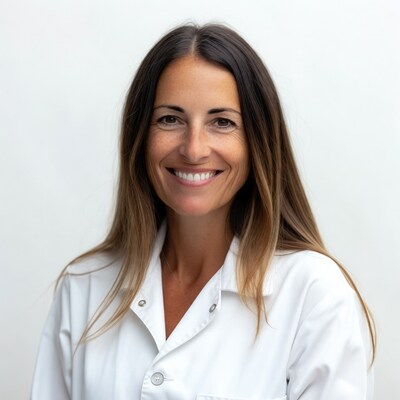 Smiling woman in white lab coat