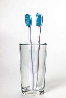 Two toothbrushes in glass