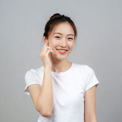 Asian woman smiling touching face