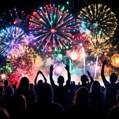 Crowd cheering at colorful fireworks display