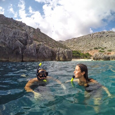 Couple snorkeling in turquoise cove