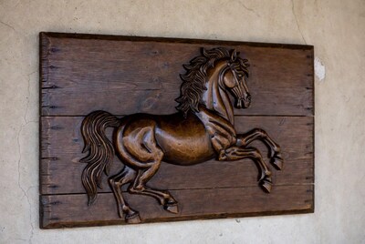 Carved wooden horse relief