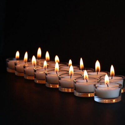 Row of burning tea light candles