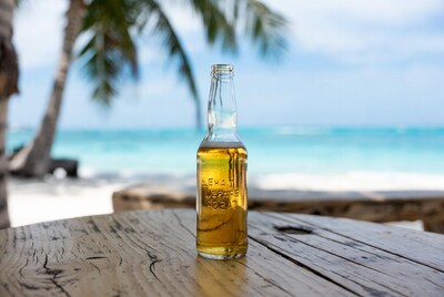 Beer bottle on table with beach background